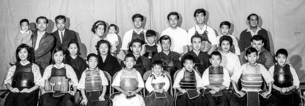 Norwalk Kendo Dojo members in December 1965. Kodama is in the 1st row, 2nd from left. Her uncle and head instructor, Akio Hara, is in the 2nd row, 4th from left. The Yamaguchi brothers, Makoto and Takeshi Yamaguchi, are sitting next to Hara.