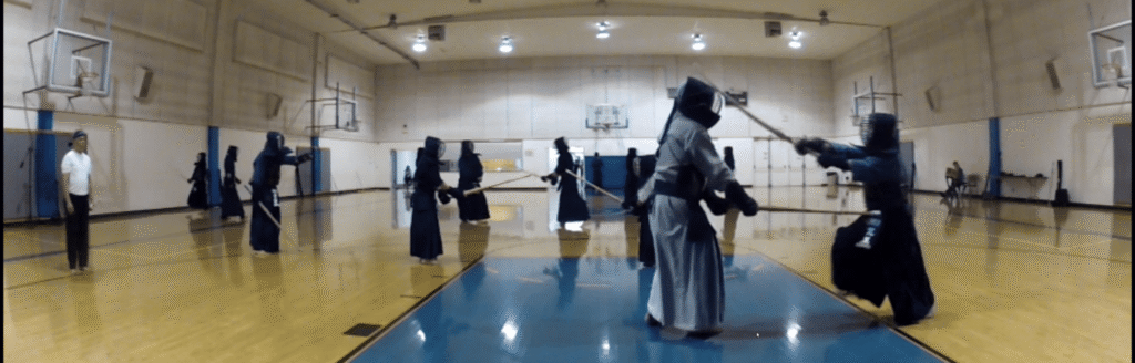 Despite her injuries, Kodama continues to provide instruction as she spars with a student.