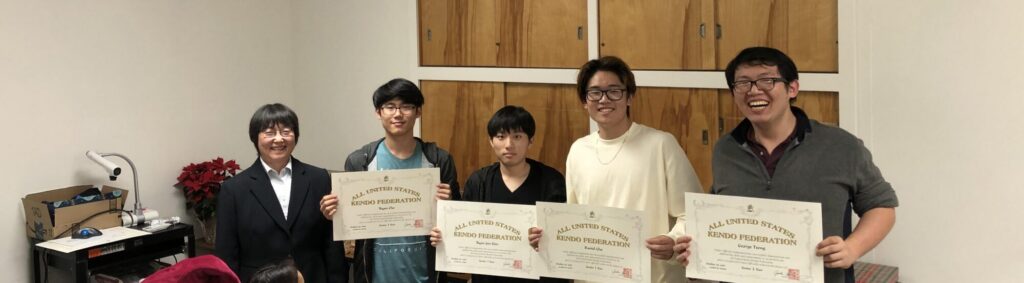 Norwalk Kendo students in the dressing room, pose with their black belt certificates at the 2019 Norwalk Dojo Christmas party. A primary focus for Kodama is to ensure students are ready for their promotional examinations.