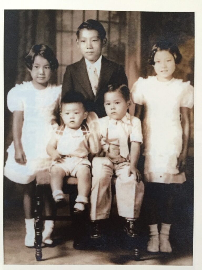 Norm (front row on the left) with his siblings