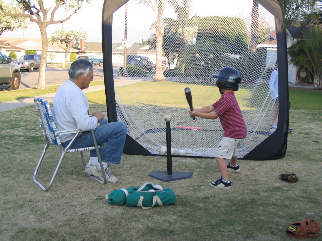 Norm teaching his grandson Chad how to swing the bat
