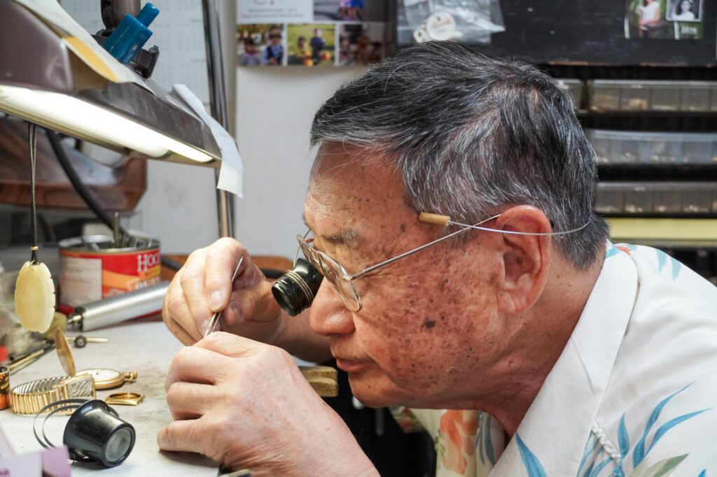 Following in his father’s footsteps, Patrick Seki repairs watches while conducting his shigin lessons afterhours.