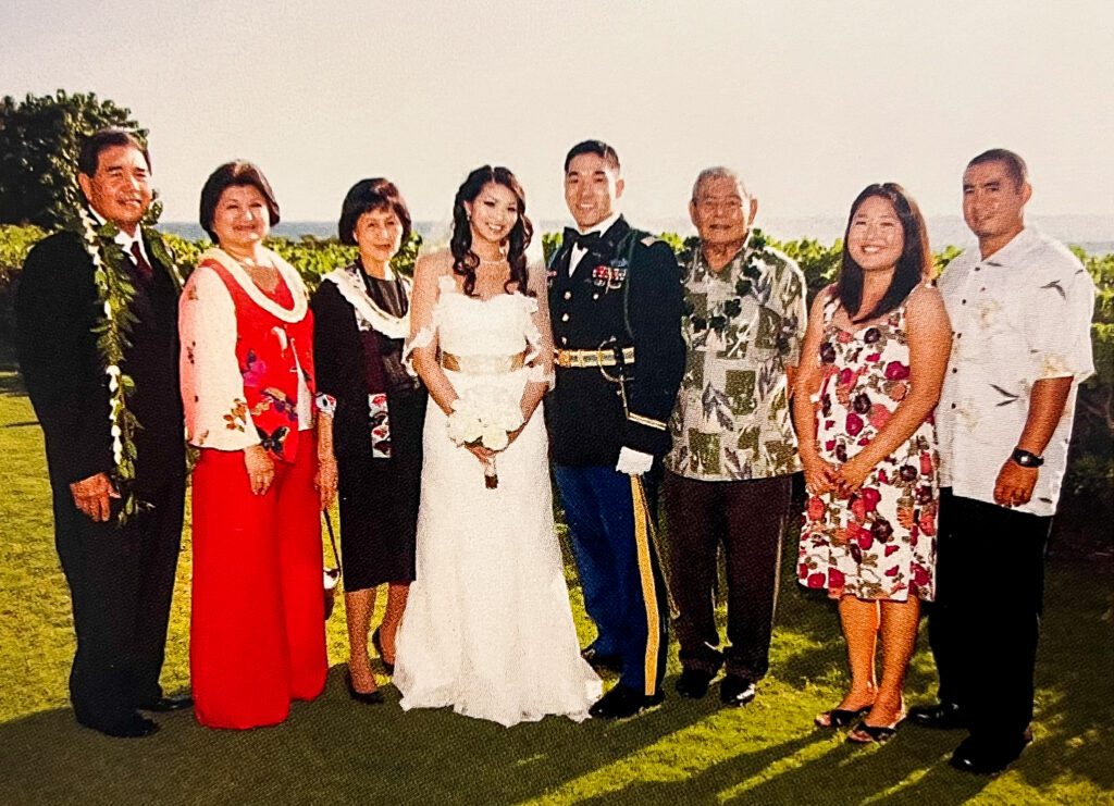 At her granddaughter's wedding in 2010 at the Four Seasons Resort, Oahu. From left to right: Son-in-law (Glenn Arakaki), daughter (Rhonda Arakaki), Saiki, granddaughter (Krislen Kanase), grandson-in-law (Daijiro Kanase), son-in-law's father (Kiyoshi Arakaki), granddaughter-in-law (Cara Arakaki), and grandson (Brenton Arakaki).
