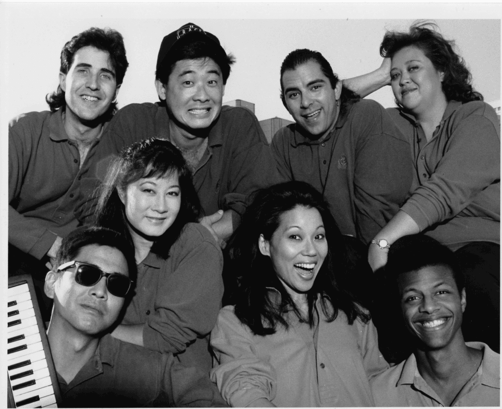 1990 - L to R, Back row: Jim MacNerland, Joey Miyashima, Geoff Rivas, Amy Hill Front row: Scott Nagatani, Denice Kumagai, Marilyn Tokuda, Phil LaMarr