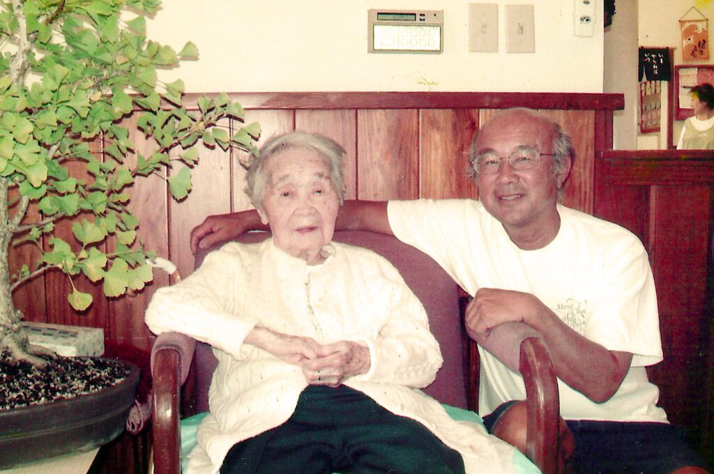 With his mother, Masuye, at 100 years old. The ginkgo bonsai shown on the left is from Dennis’s collection.